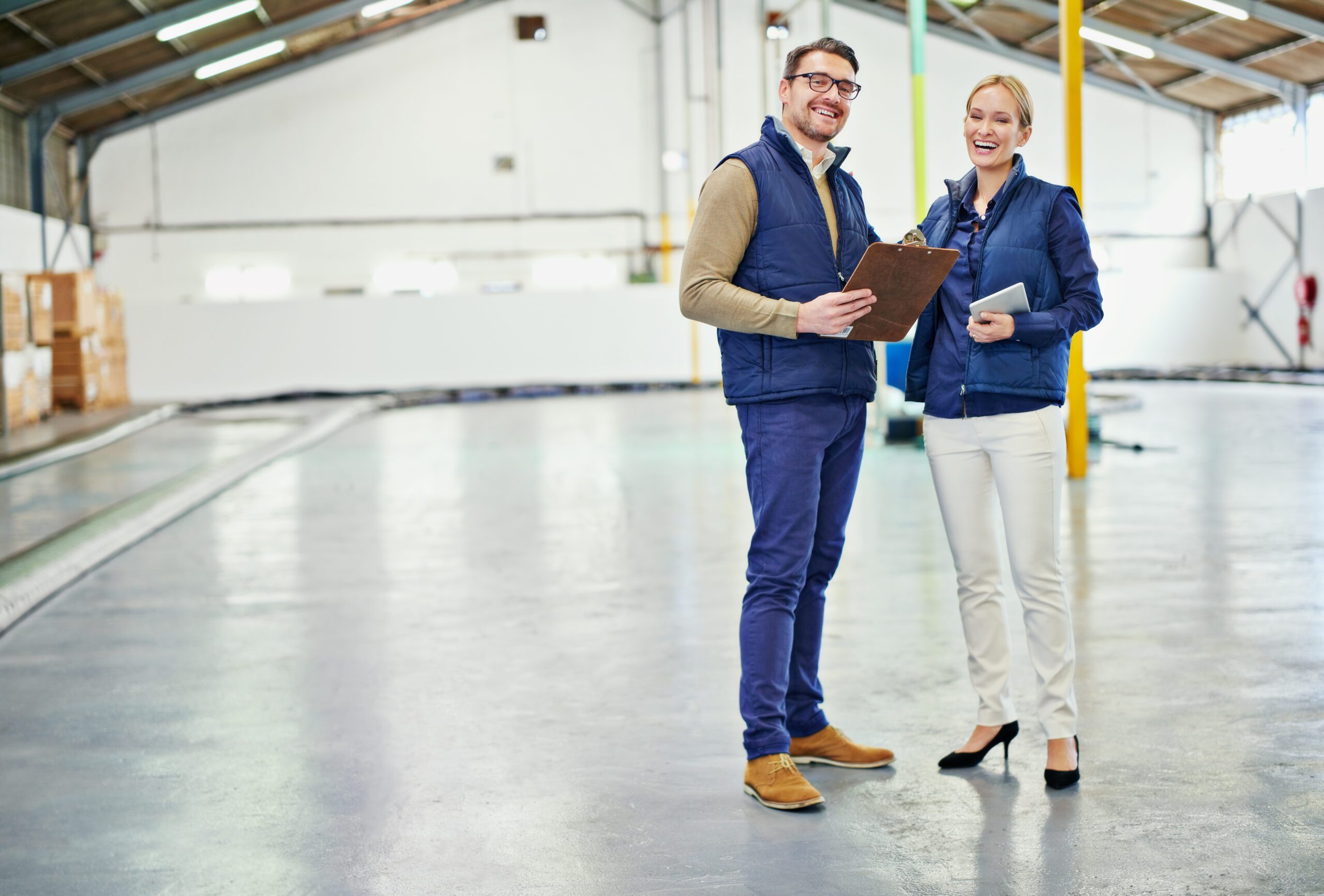 Clearing the warehouse floor. Portrait of two floor managers working in a large warehouse