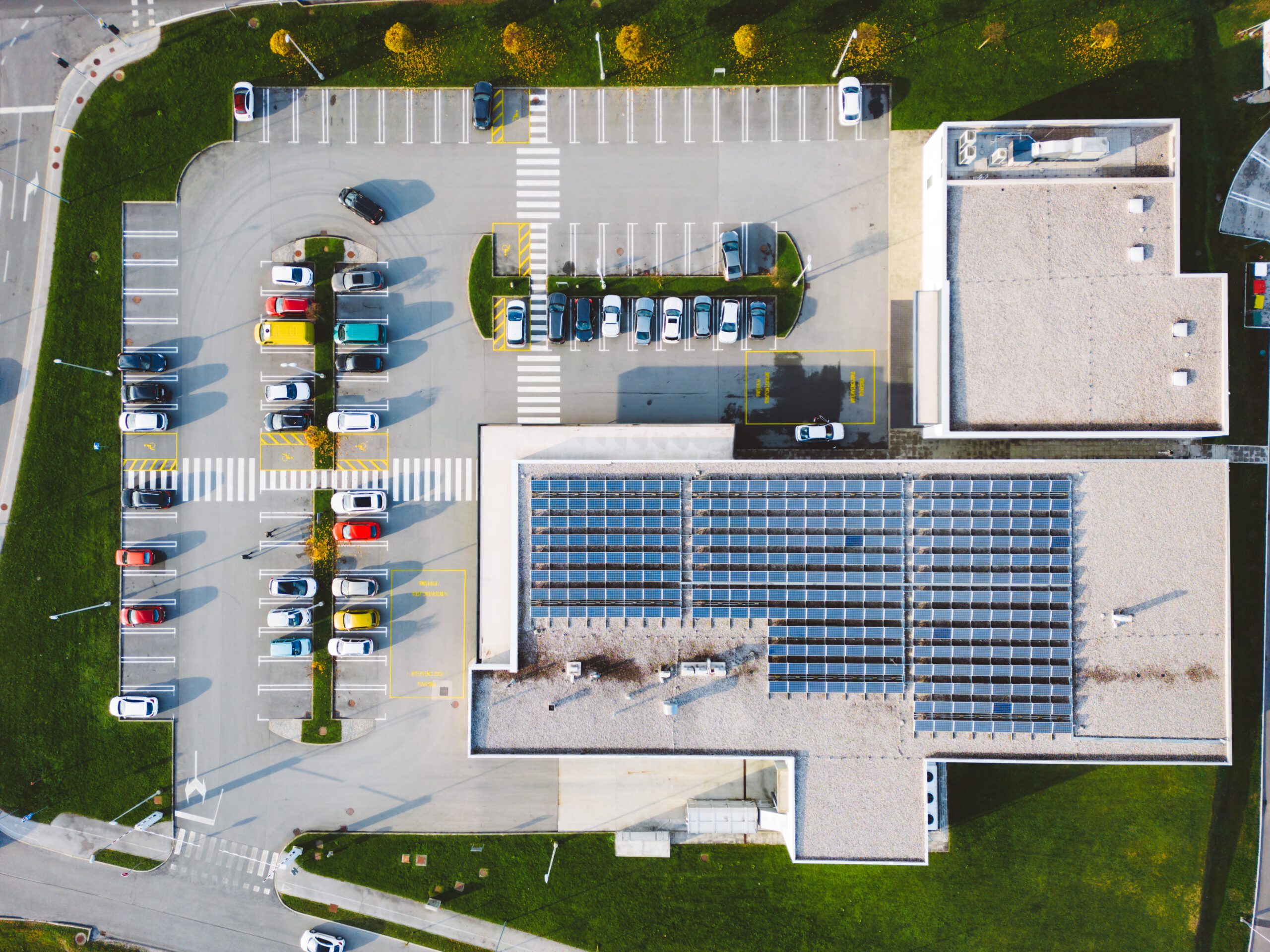 Rooftop Solar Panel Installation in DFW - LBJ Roofing Company Corp. Aerial view of commercial building rooftop with installed solar panels